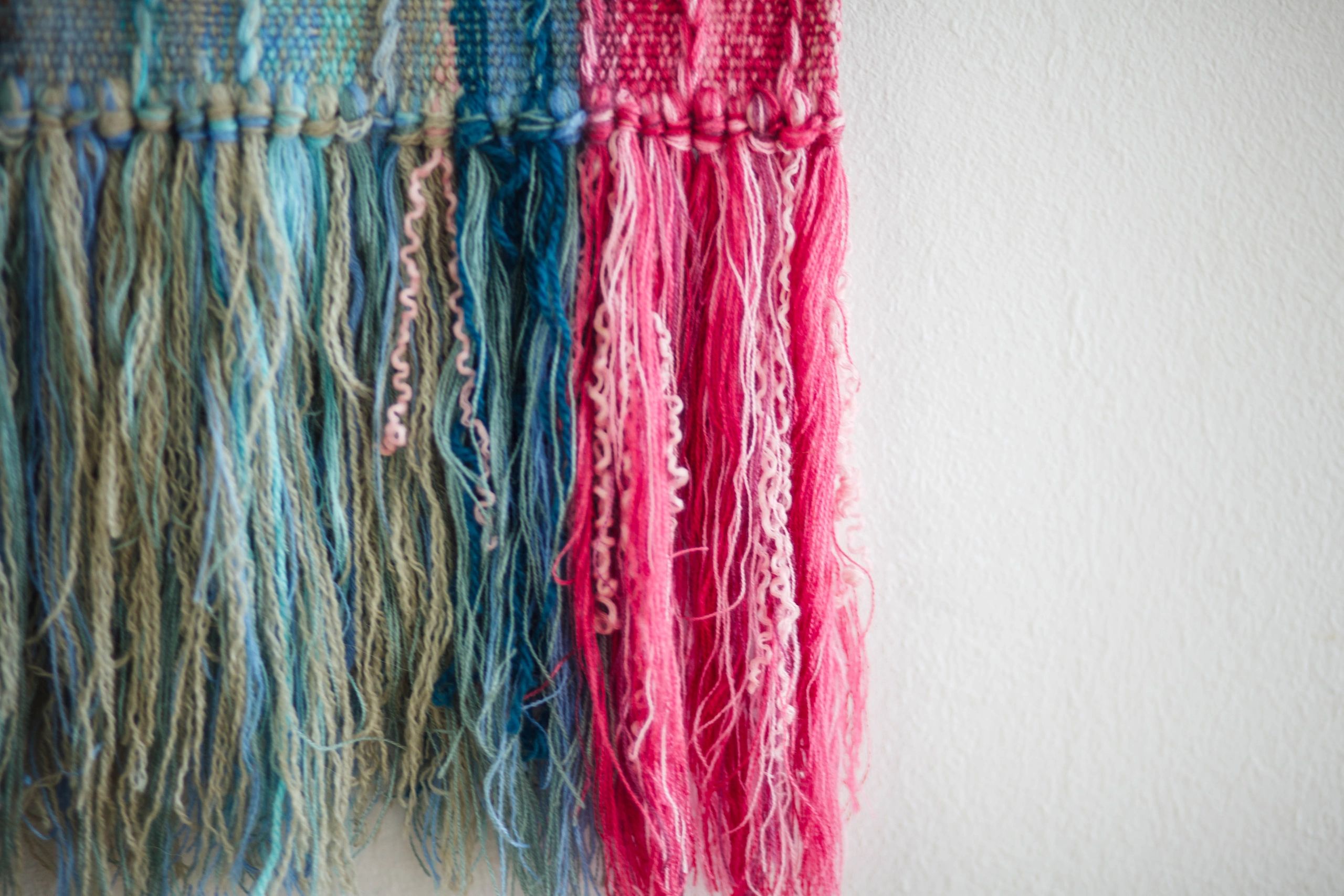 Handmade woven wall decor with colorful threads